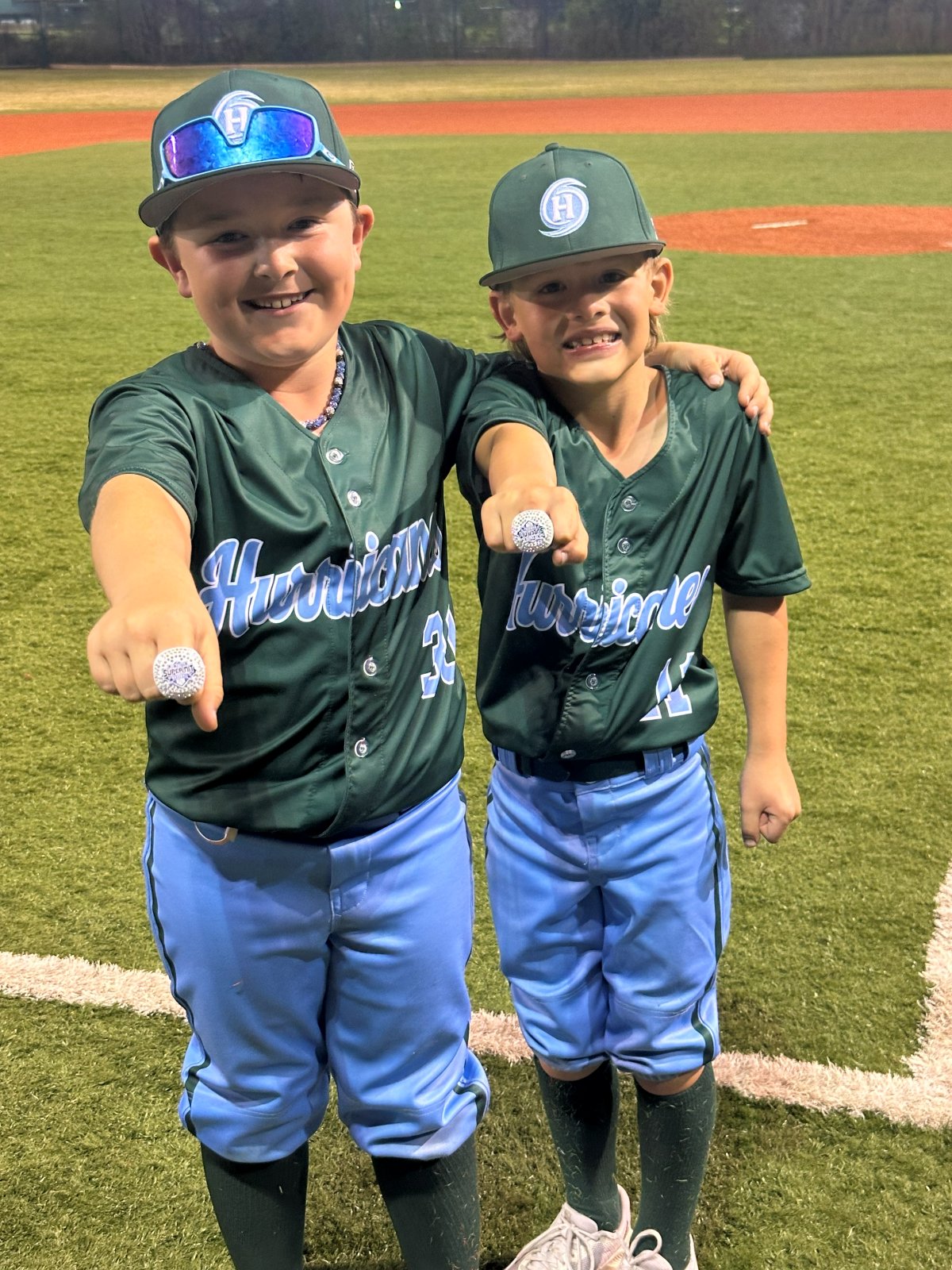 Two players holding up their rings
