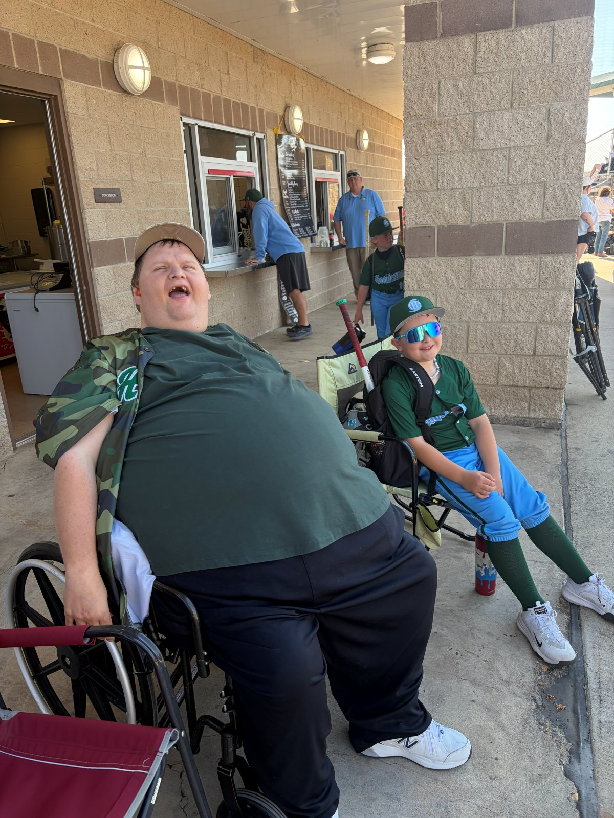 Patrick laughing at the ballpark with a Hurricanes player