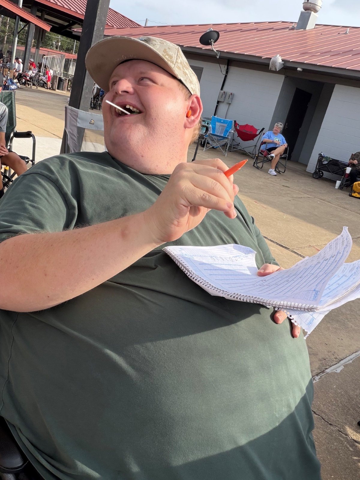 Patrick at the ballpark holding the scorebook